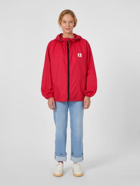 Veste coupe-vent unisexe Rouge, présenté sur un modèle