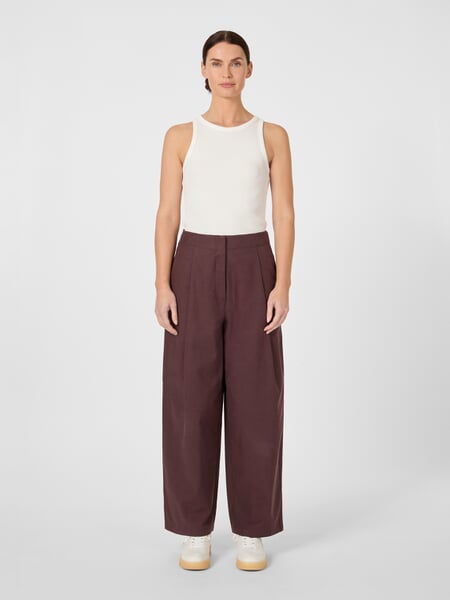 Women's Pleated Pants Wine red, presented on a model
