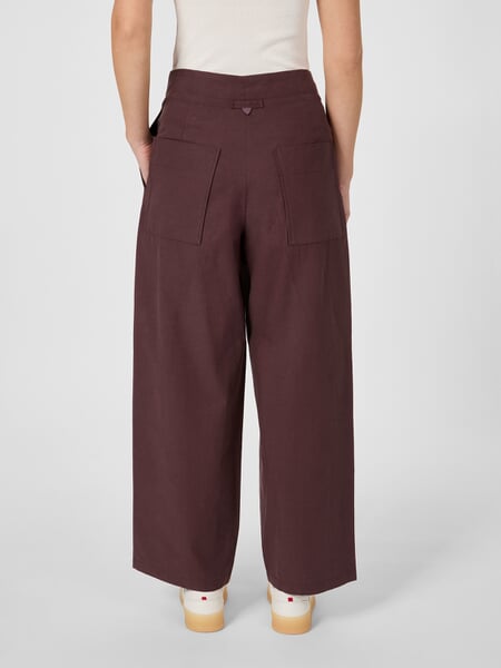 Women's Pleated Pants Wine red, presented on a model