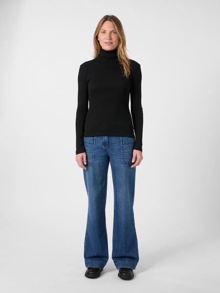 Women’s Turtleneck Shirt Black, presented on a model