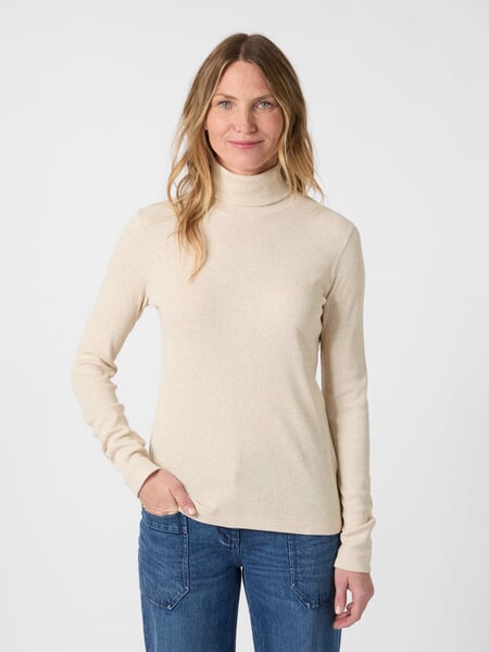 Women’s Turtleneck Shirt Natural white, presented on a model