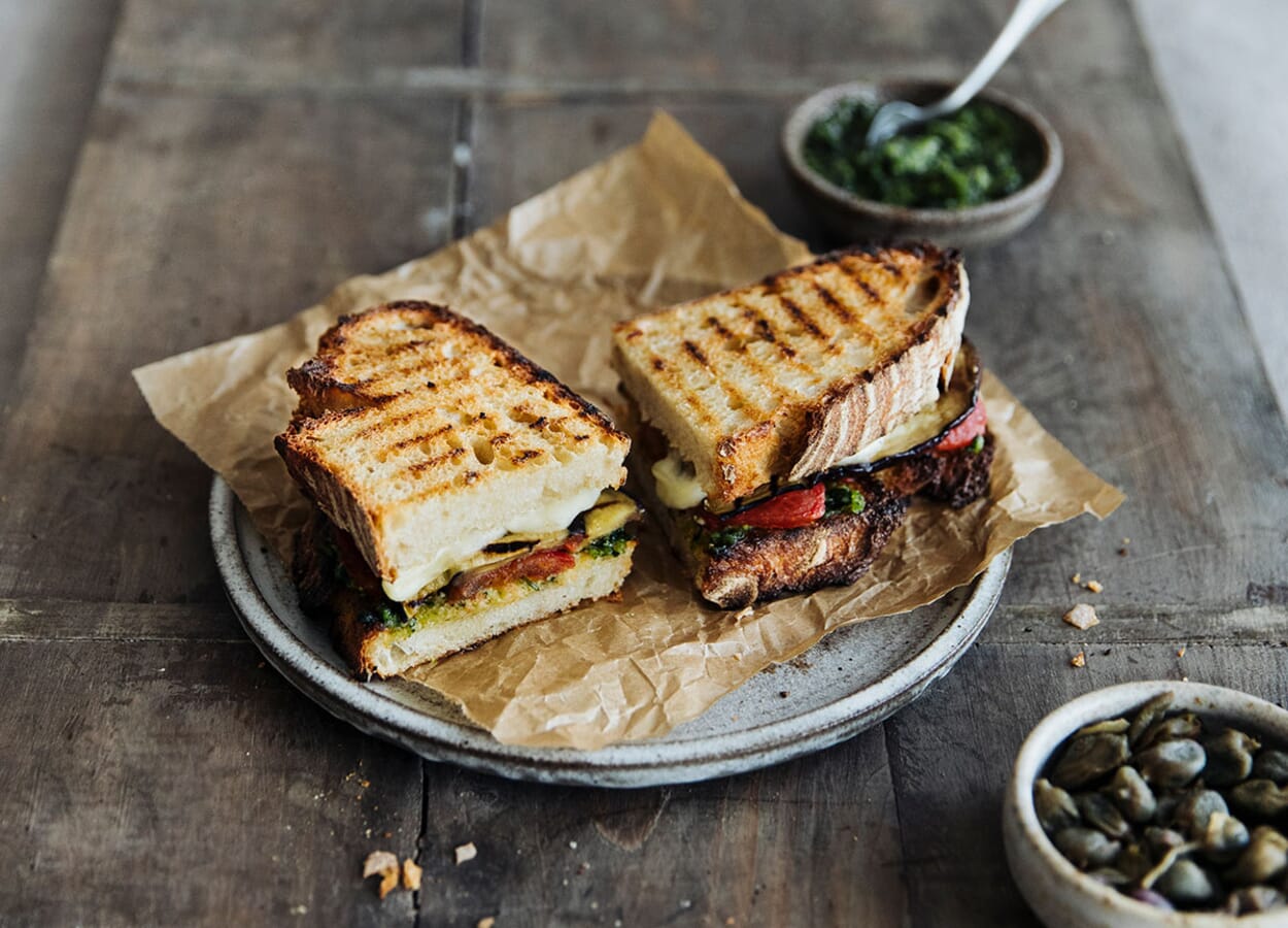 Panini with grilled vegetables, basil pesto, mozzarella and salted capers