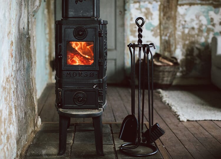 Forged fireplace set next to a fireplace